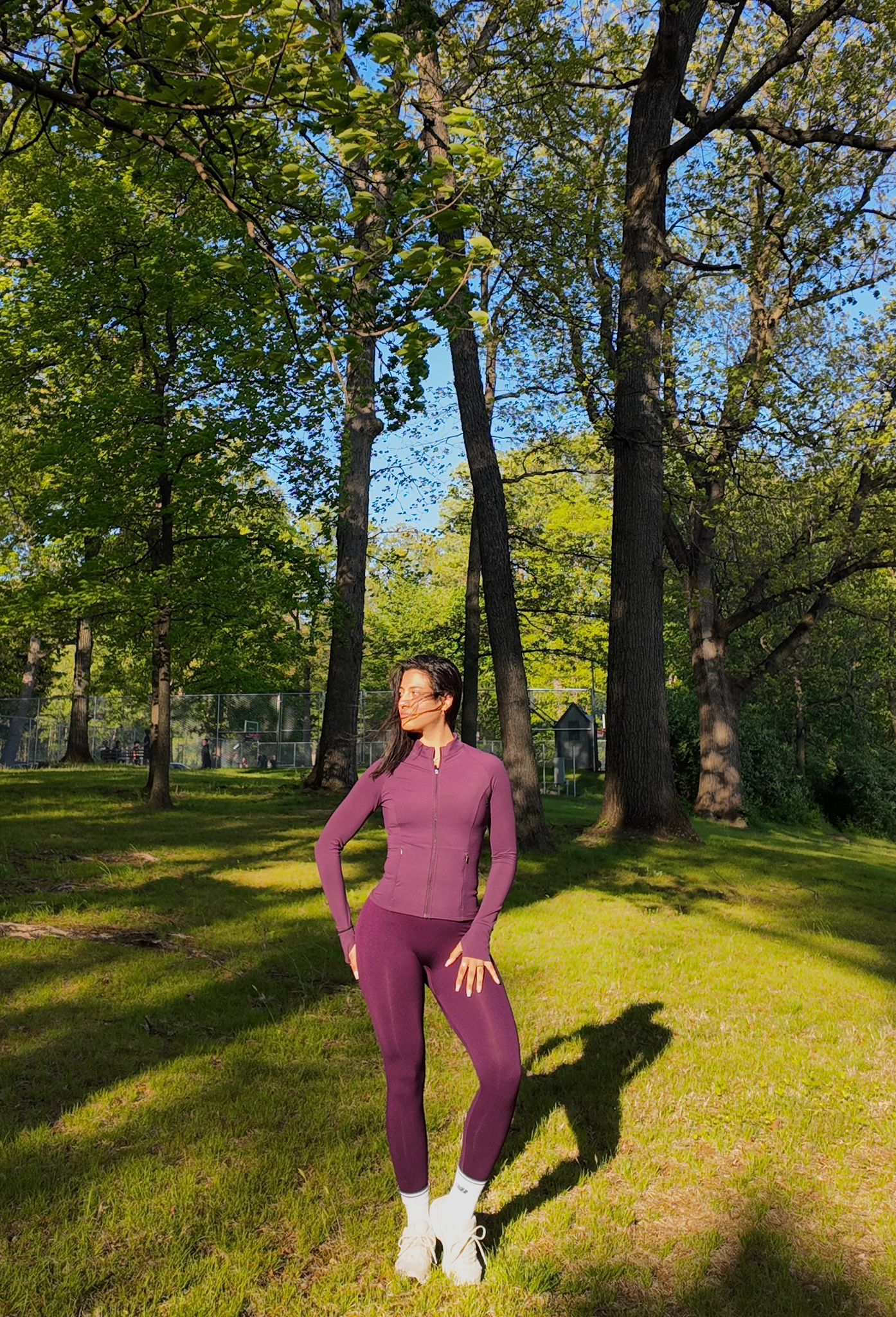 Fit by Faith founder in maroon activewear outdoors